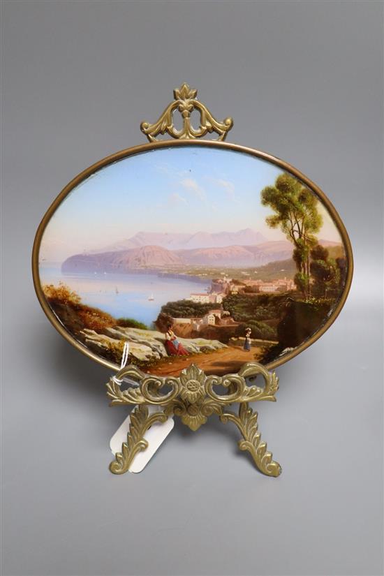 A Neapolitan oval reverse painting on glass of the Bay of Naples, miniature width 20cm, with a small brass easel